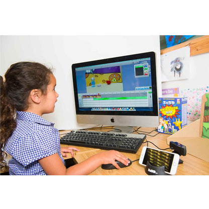 A young girl uses ZU3D to animate a toy and background on a PC.