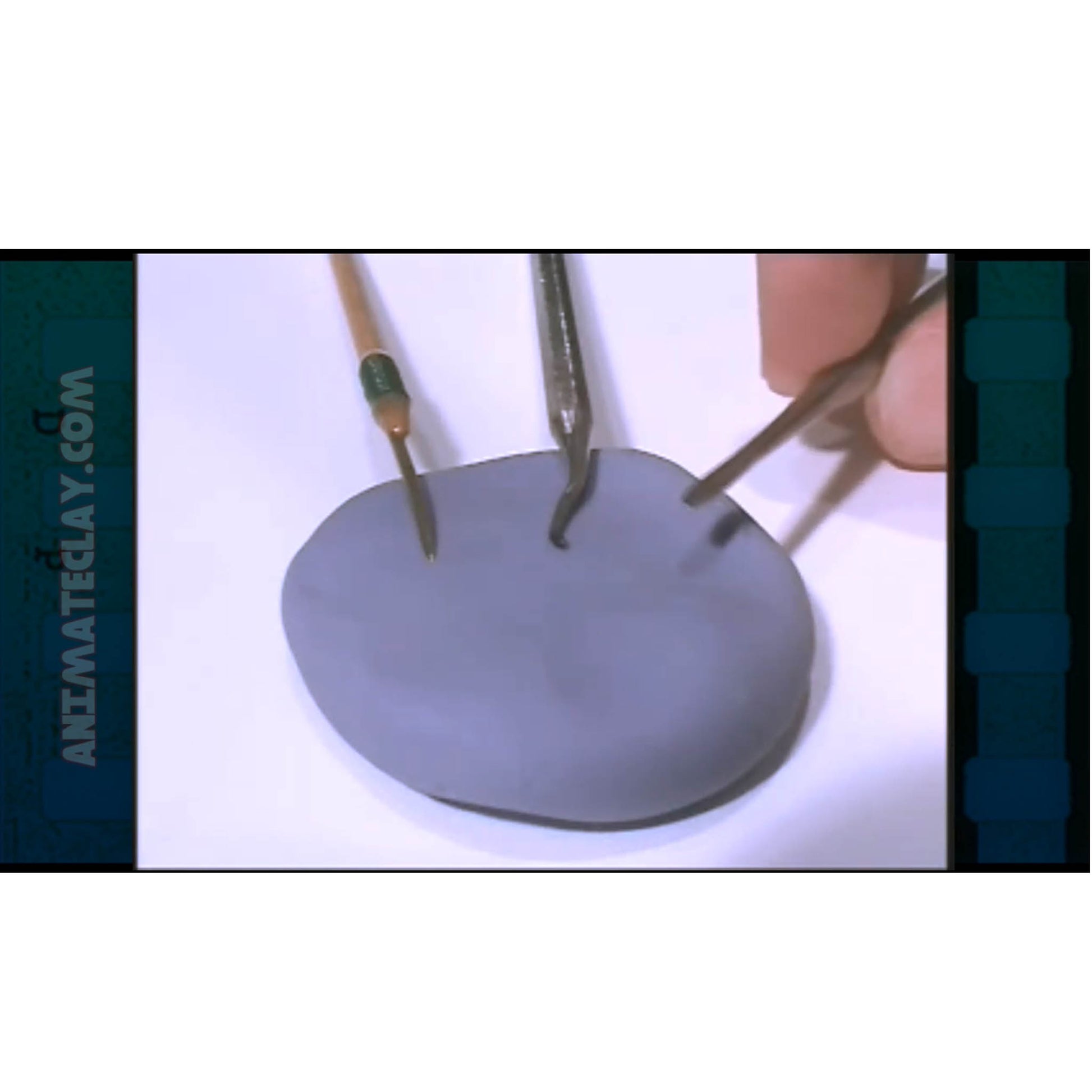 Three sculpting tools and a flattened ball of clay.