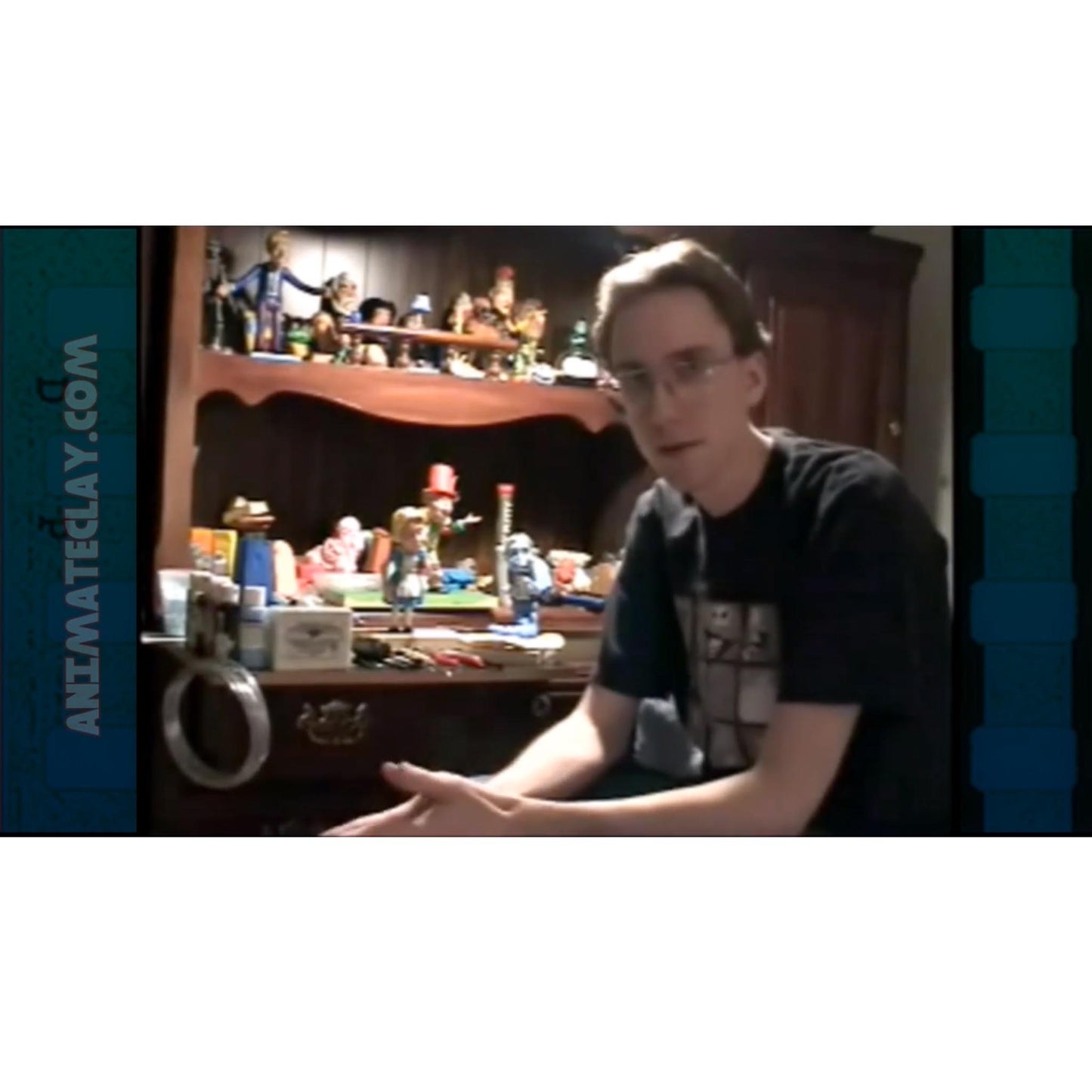 Marc (when he was still young) at his desk of clay puppets.